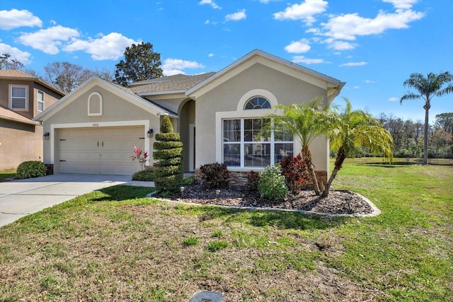 ranch-style home featuring a garage, driveway, a front yard, and stucco siding