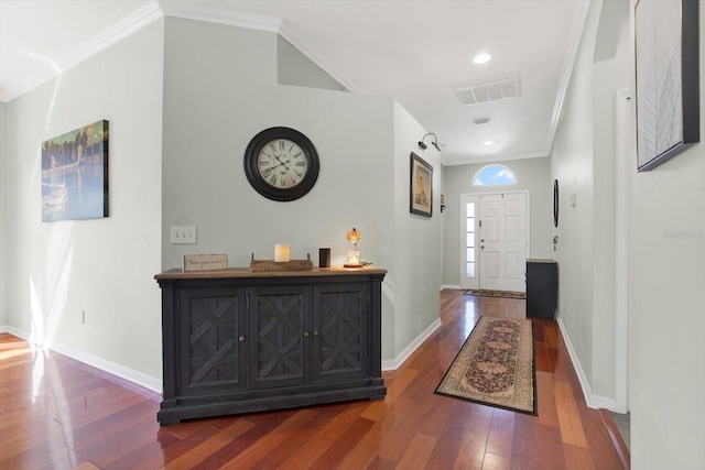 foyer featuring visible vents, crown molding, baseboards, and hardwood / wood-style flooring