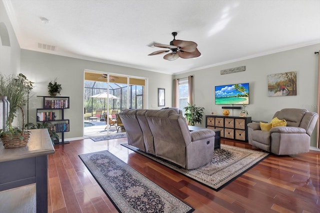 living room featuring visible vents, ornamental molding, a ceiling fan, a sunroom, and wood finished floors