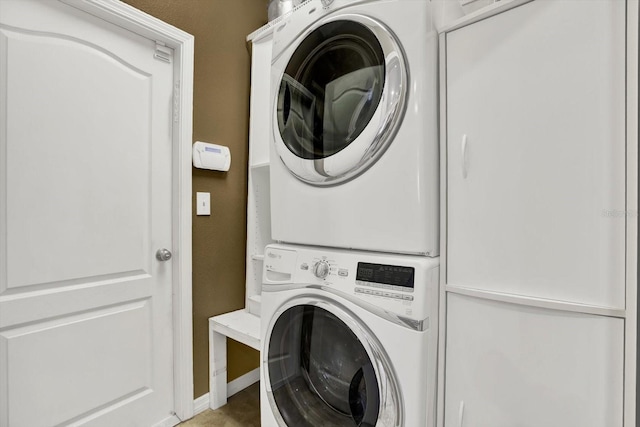 clothes washing area featuring laundry area and stacked washer / drying machine