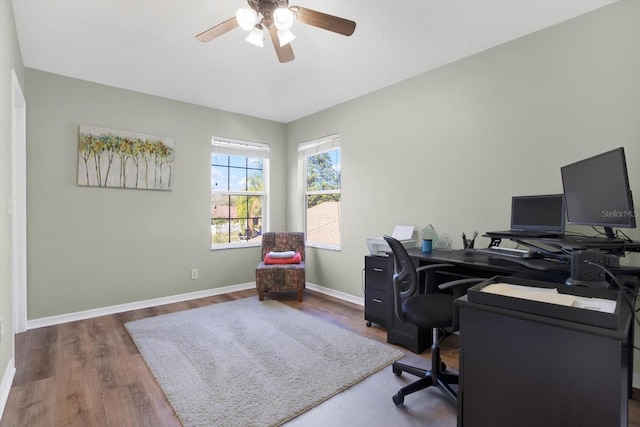 office area featuring ceiling fan, baseboards, and wood finished floors