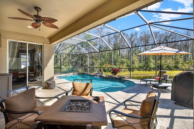 view of patio featuring ceiling fan, an outdoor fire pit, a lanai, grilling area, and an outdoor pool