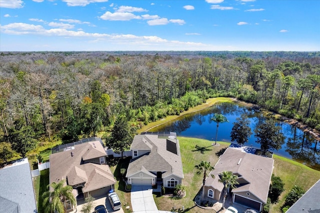 bird's eye view featuring a water view and a wooded view