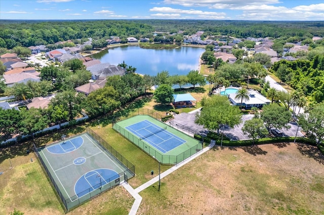 birds eye view of property with a water view and a wooded view