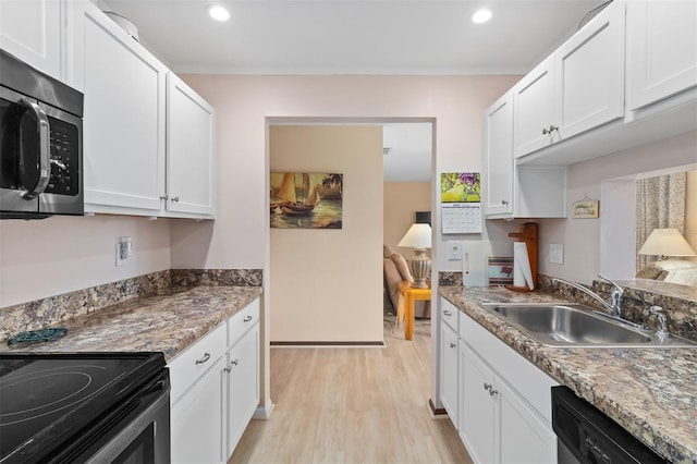 kitchen featuring sink, stainless steel appliances, light hardwood / wood-style floors, and white cabinets