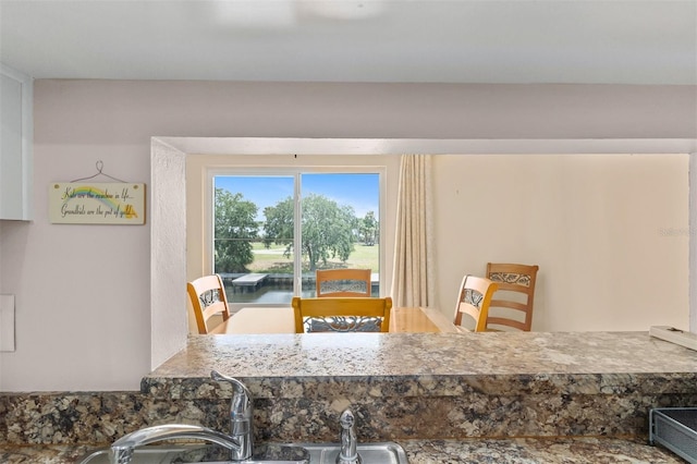 dining area featuring a water view