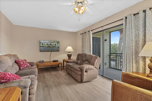 living room featuring ceiling fan and light hardwood / wood-style floors