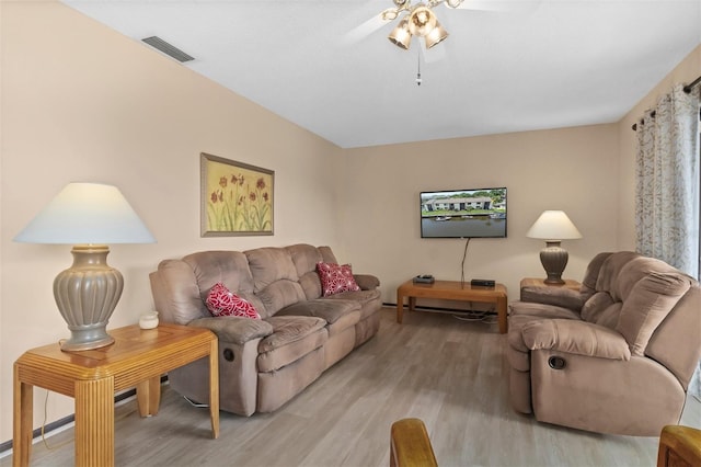living room featuring ceiling fan and light wood-type flooring
