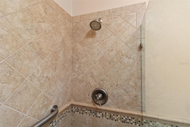 interior details with a tile shower