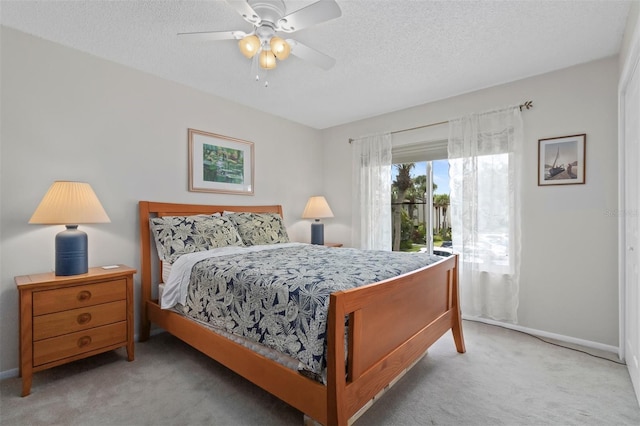 bedroom with access to exterior, ceiling fan, a textured ceiling, and carpet