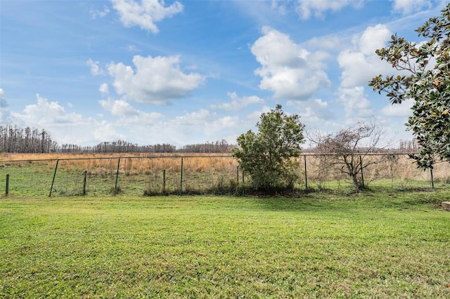 view of yard featuring a rural view and fence