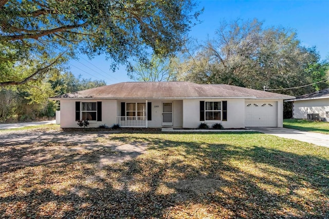 single story home featuring covered porch, a garage, and a front lawn