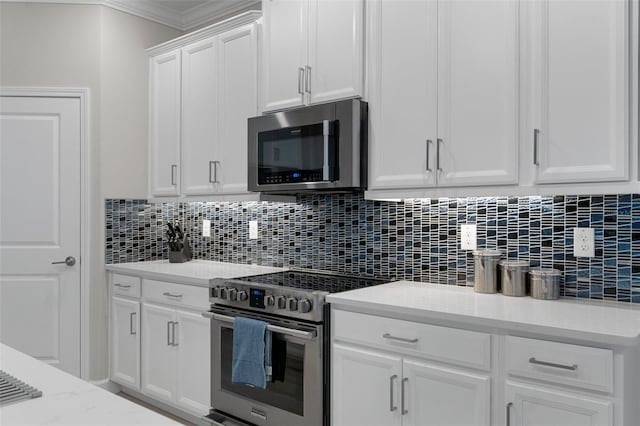 kitchen featuring tasteful backsplash, crown molding, light stone counters, appliances with stainless steel finishes, and white cabinets