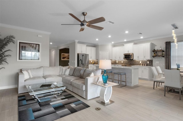 living room with visible vents, ornamental molding, a ceiling fan, recessed lighting, and baseboards