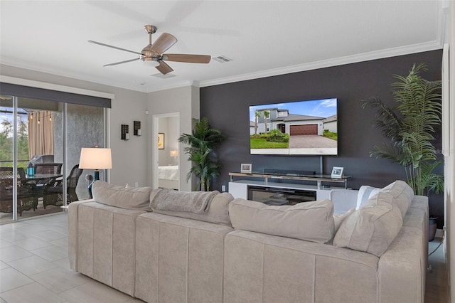 living room with an accent wall, crown molding, a ceiling fan, and visible vents