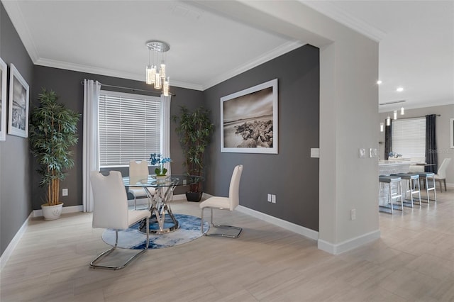 dining space featuring a chandelier, wood finished floors, baseboards, and ornamental molding