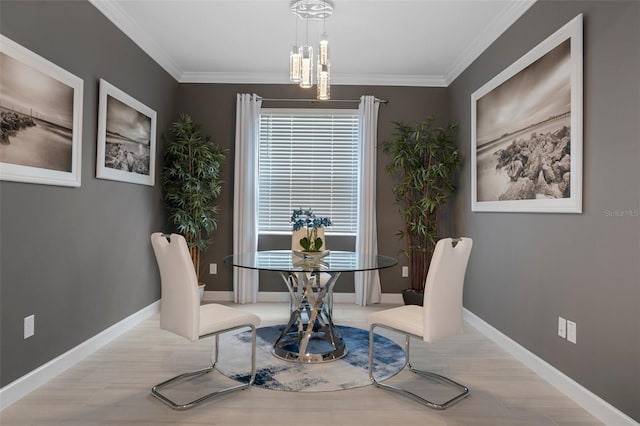 dining space featuring crown molding, baseboards, and wood finished floors