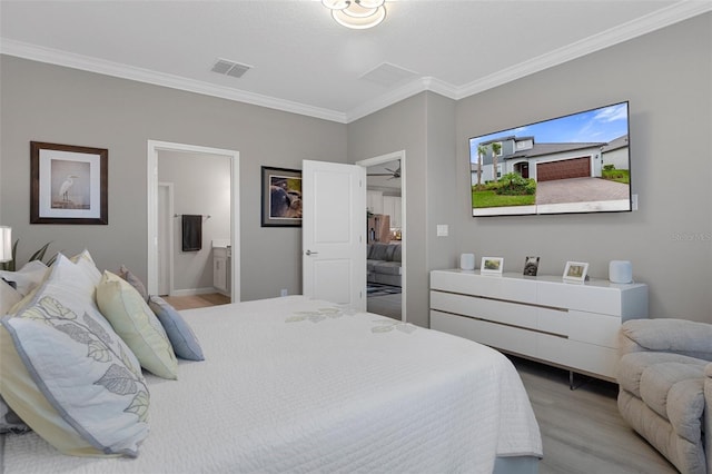 bedroom with ensuite bath, crown molding, light wood-style flooring, and visible vents