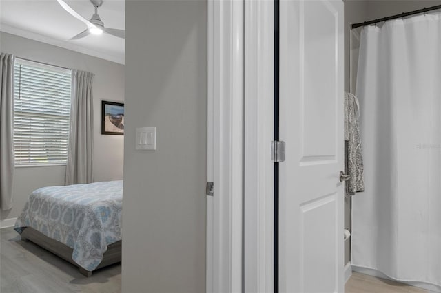 bedroom with ceiling fan, light wood finished floors, and ornamental molding