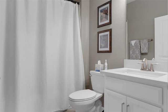 full bathroom featuring vanity and toilet