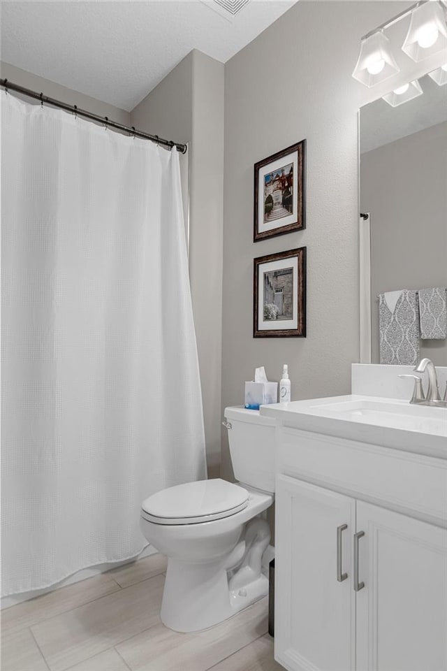 full bath featuring toilet and vanity