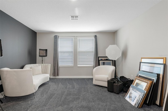 living area with visible vents, baseboards, and carpet