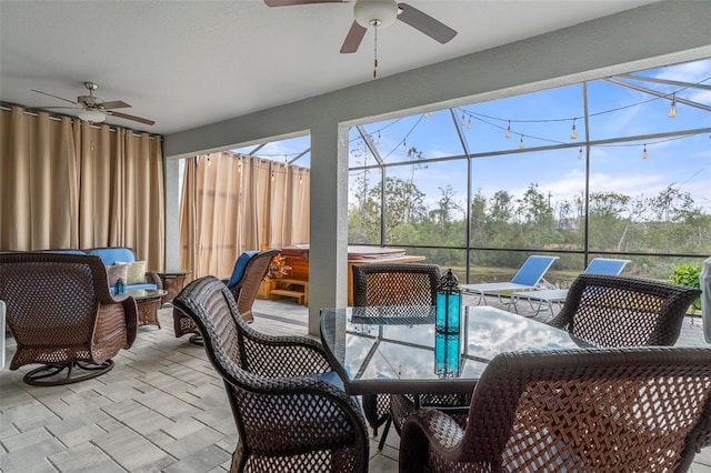 sunroom / solarium featuring a ceiling fan