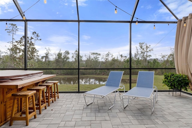 unfurnished sunroom featuring a water view