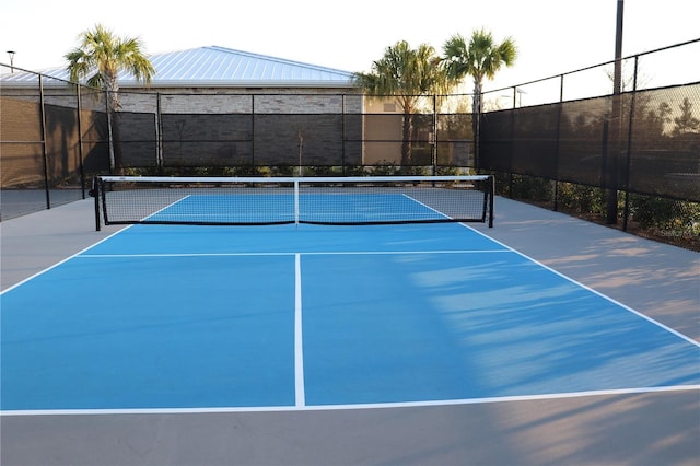 view of sport court featuring fence