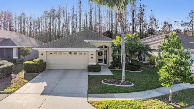 single story home with a garage and a front yard