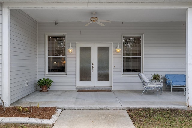 view of exterior entry featuring french doors, a patio, and ceiling fan