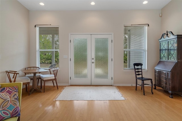 doorway featuring baseboards, french doors, recessed lighting, and light wood-style floors