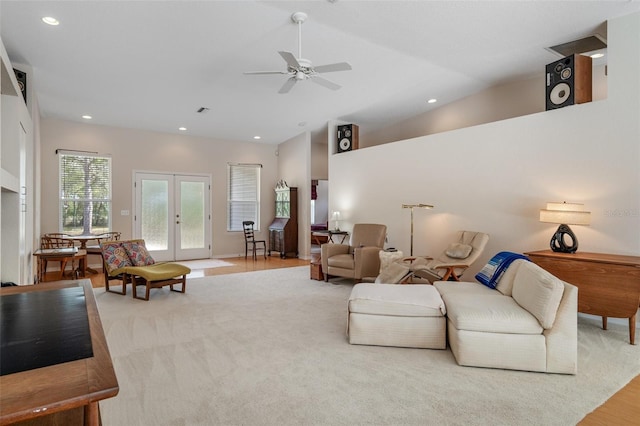 living room with lofted ceiling, recessed lighting, a ceiling fan, and french doors