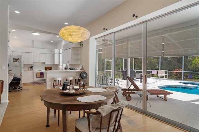 dining area with recessed lighting, a healthy amount of sunlight, and light wood finished floors