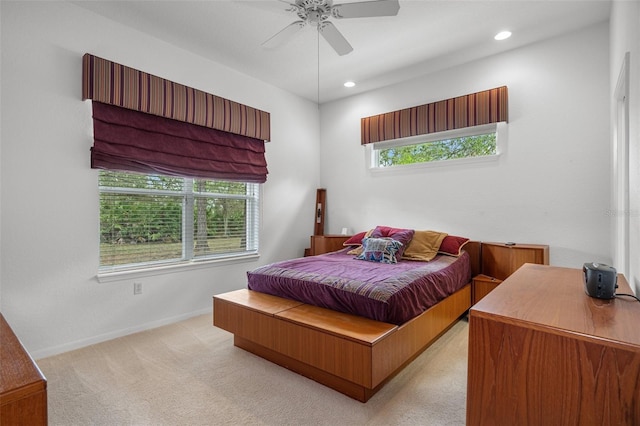 bedroom featuring light carpet, multiple windows, recessed lighting, and baseboards