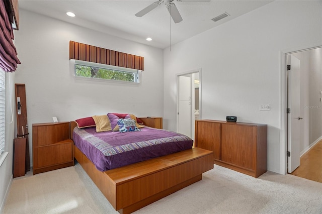 bedroom featuring recessed lighting, light colored carpet, ceiling fan, and ensuite bathroom