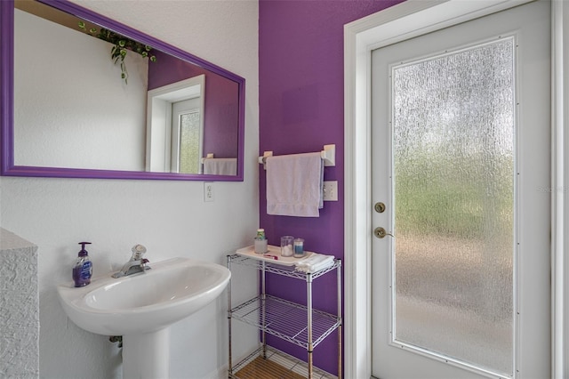 bathroom with a sink and a healthy amount of sunlight