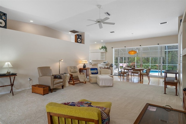 living area with ceiling fan, baseboards, visible vents, and light colored carpet