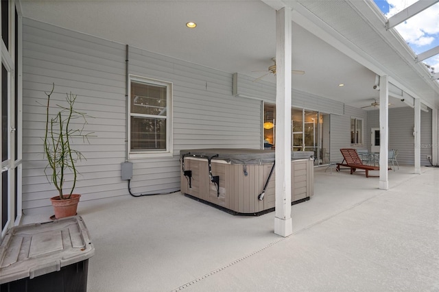 view of patio / terrace with a hot tub and a ceiling fan