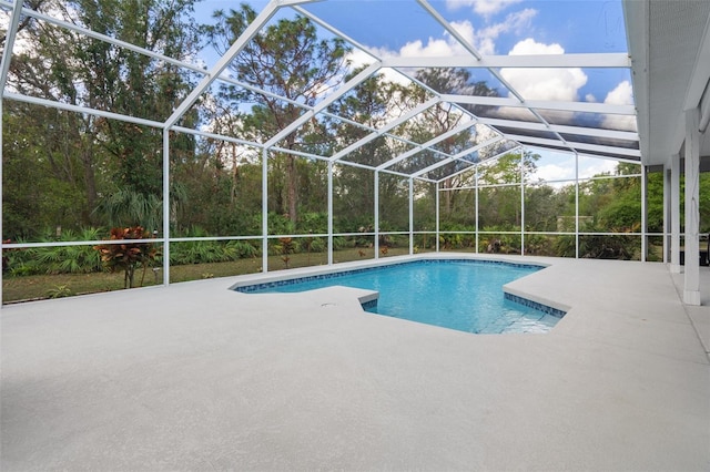 pool with a lanai and a patio area