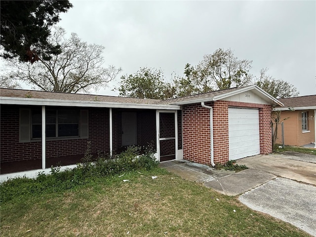 ranch-style home featuring a garage and a front lawn