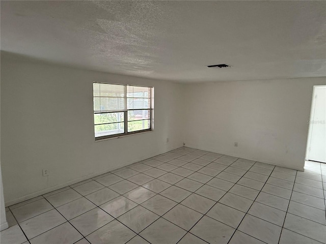 spare room featuring a textured ceiling