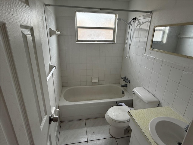 full bathroom with vanity, tile patterned flooring, tiled shower / bath combo, and toilet