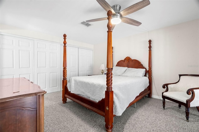 carpeted bedroom with two closets and ceiling fan