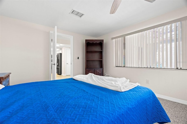 bedroom with ceiling fan, stainless steel fridge, and carpet flooring