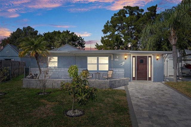 view of front of property with a lawn