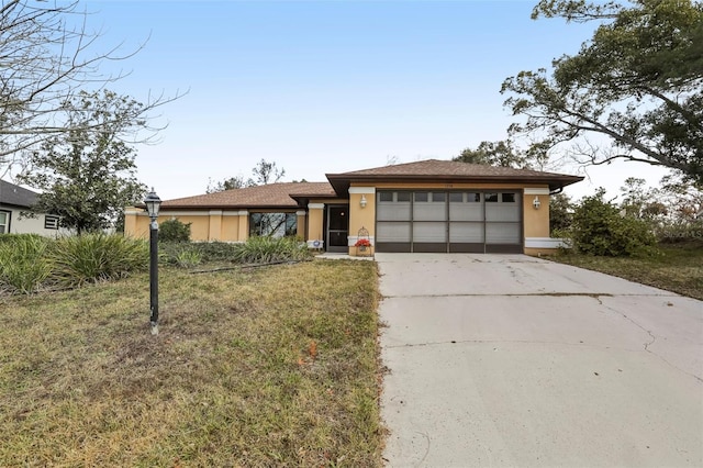 view of front of home with a garage and a front yard