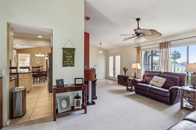 tiled living room featuring lofted ceiling, ceiling fan with notable chandelier, french doors, and a textured ceiling