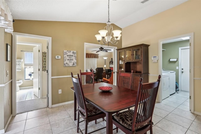 dining space featuring separate washer and dryer, light tile patterned floors, ceiling fan with notable chandelier, and lofted ceiling