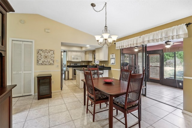 dining room featuring light tile patterned flooring, ceiling fan with notable chandelier, and vaulted ceiling